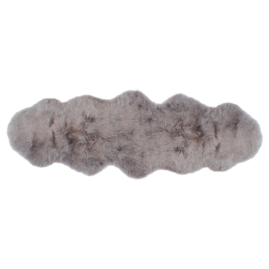 A premium sheepskin rug with a beige and white color, displayed on a white background.