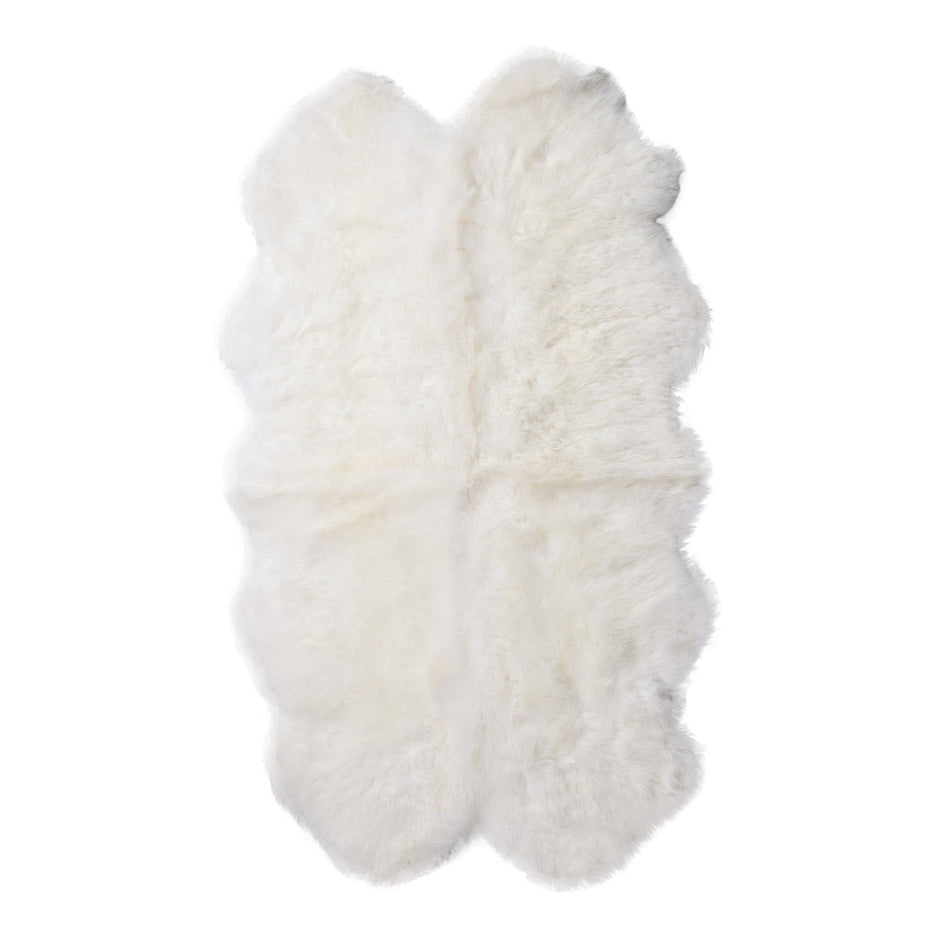 A natural-shaped white sheepskin rug