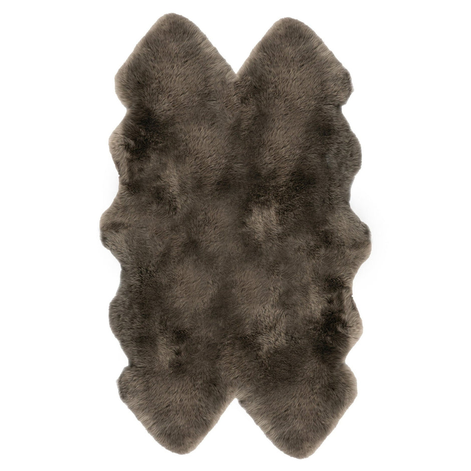 A natural-shaped brown sheepskin rug