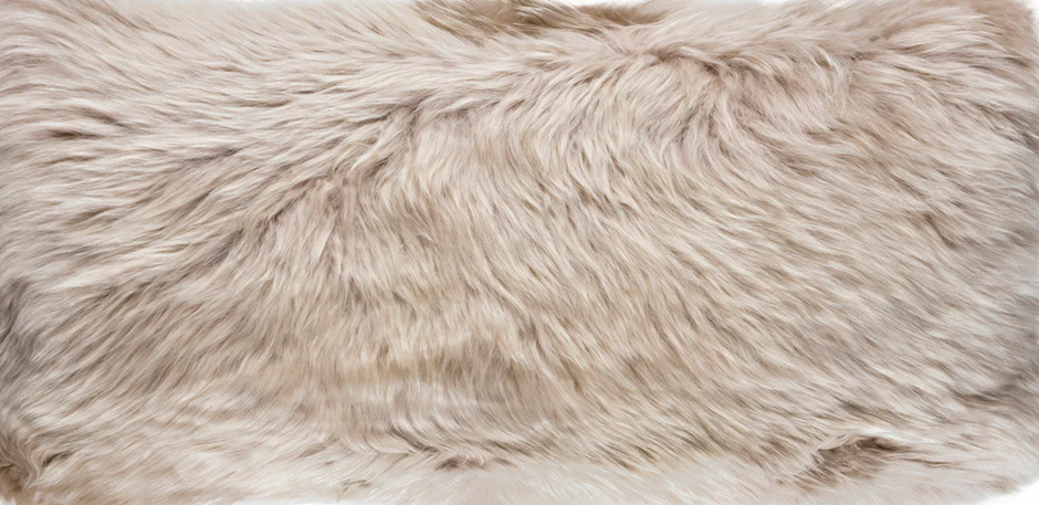 A natural-shaped white sheepskin rug