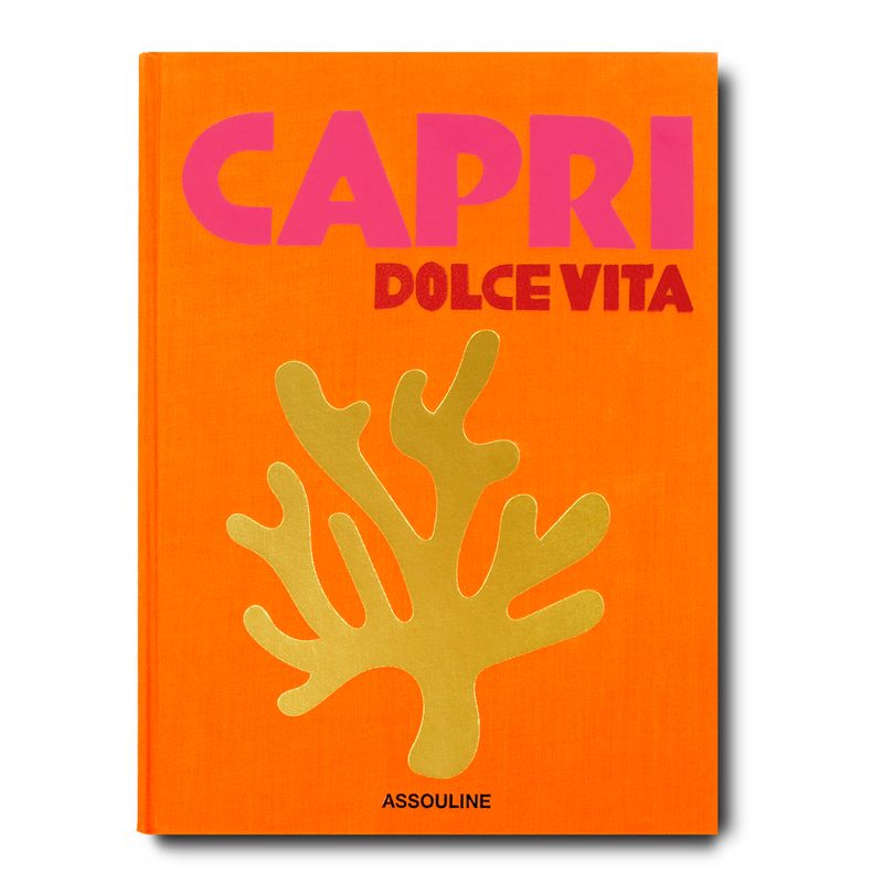 Book cover of 'Capri Dolce Vita' by Assouline with orange background, pink text, and yellow coral design.