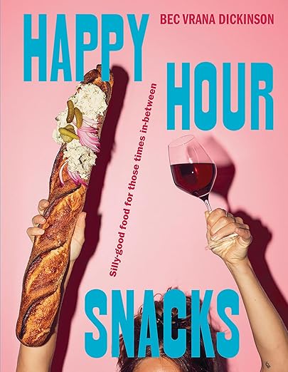Book cover of 'Happy Hour Snacks' with a pink background, baguette, and wine glass.