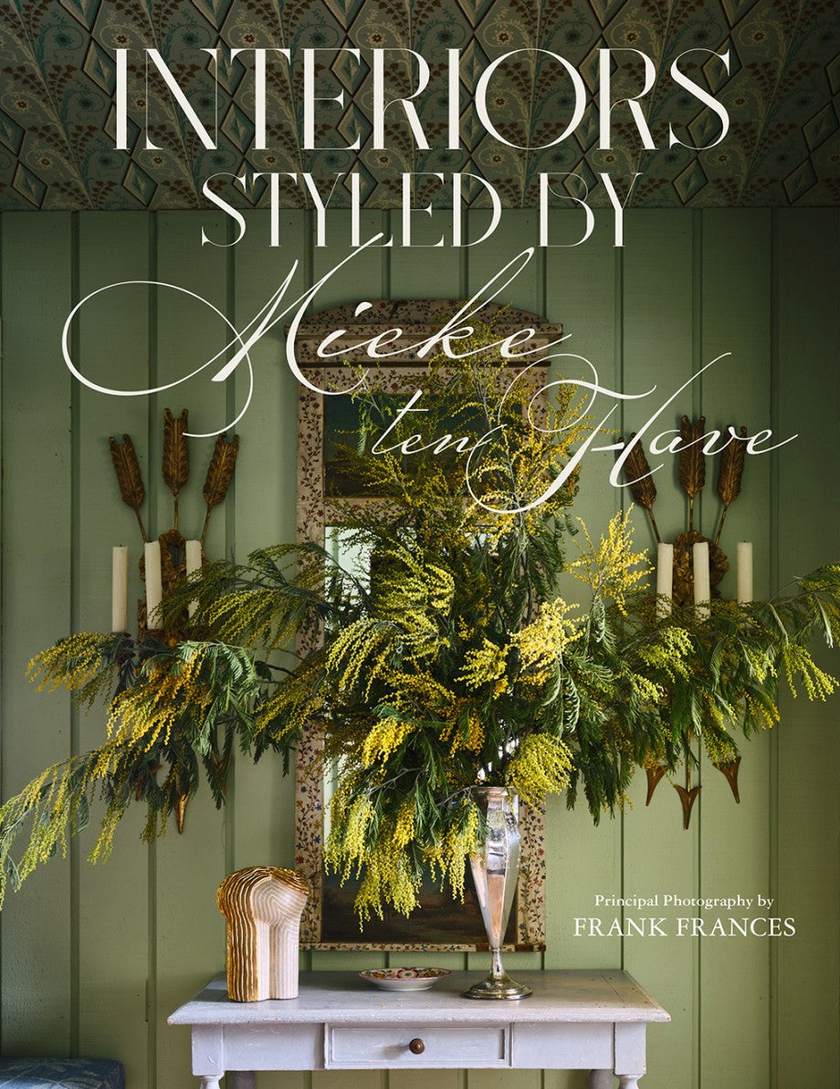 Book cover with decorative elements and text 'Interiors Styled by Neeke ten Hove' on a green background.