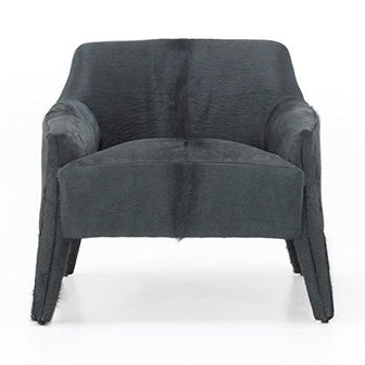 A sleek navy blue upholstered chair with a low-profile frame and Moros Petroleum fabric, featuring a tight back and seat, with options for exposed wood or upholstered legs.
