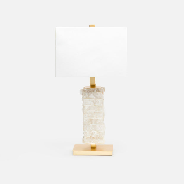 A table lamp with a textured, stacked rough hewn alabaster base in milky white and gold-finished metal accents, including a rectangular gold base and a gold finial, paired with a plain white rectangular shade, set against a solid white background.