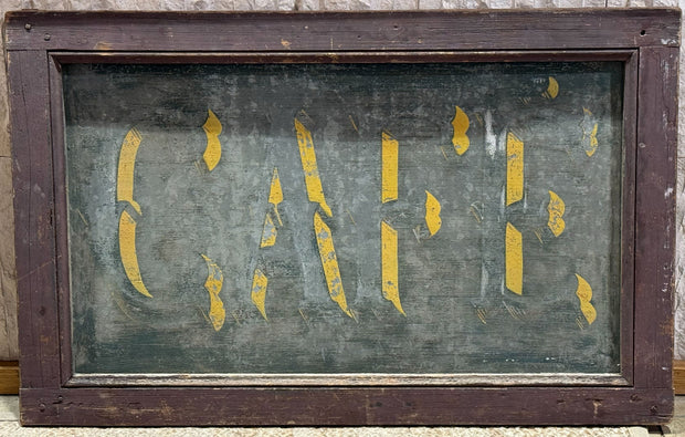 Vintage wooden sign with 'Cafe' in yellow on a green background