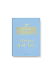 Book titled 'A Legacy by the Lake' with gold text on a light blue background