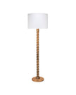 A floor lamp with a white drum shade, a twisted wooden central stem, and a round wooden base, shown against a plain white background.