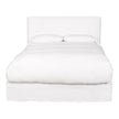 A king-sized white leather bed frame with a headboard and footboard, presented in an unmade state showcasing the mattress and pillows.