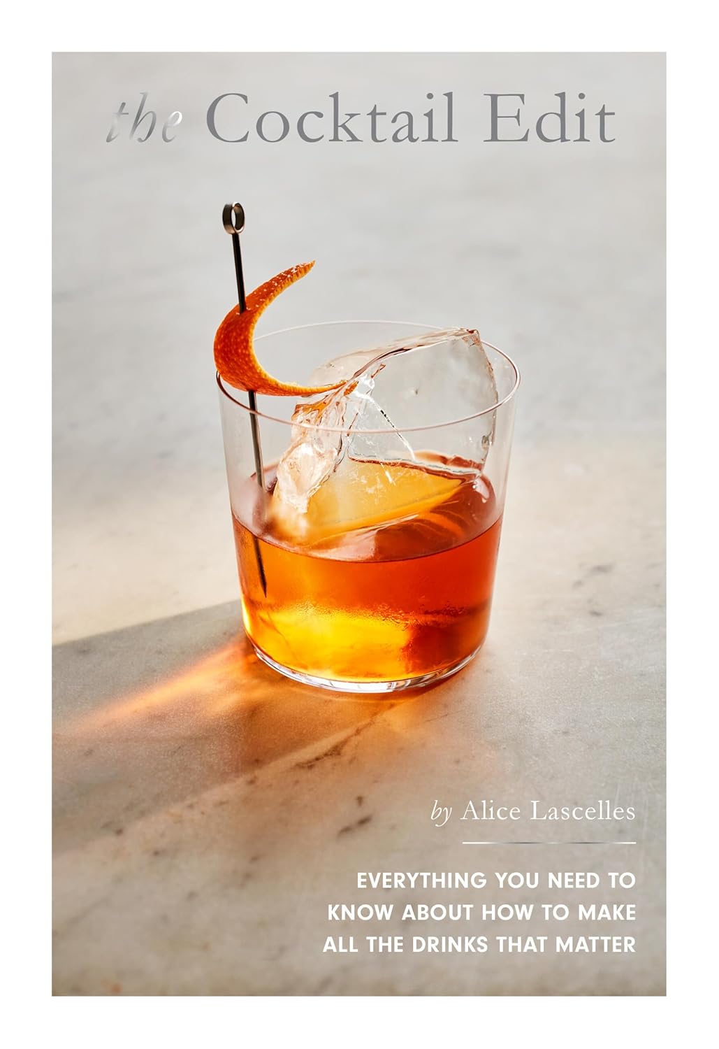 Book cover of 'The Cocktail Edit' with a cocktail on a marble surface
