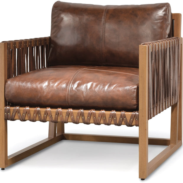 A modern accent chair featuring a brown leather seat cushion and backrest, supported by a light brown wooden frame with decorative rope details on the sides and bottom.