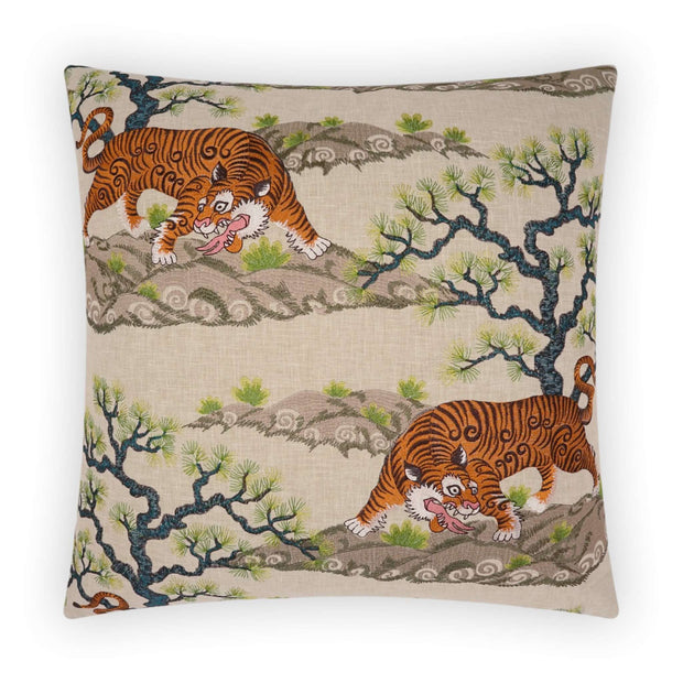 A square decorative pillow with a beige background featuring embroidery of a chonburi scene with trees and a tiger.