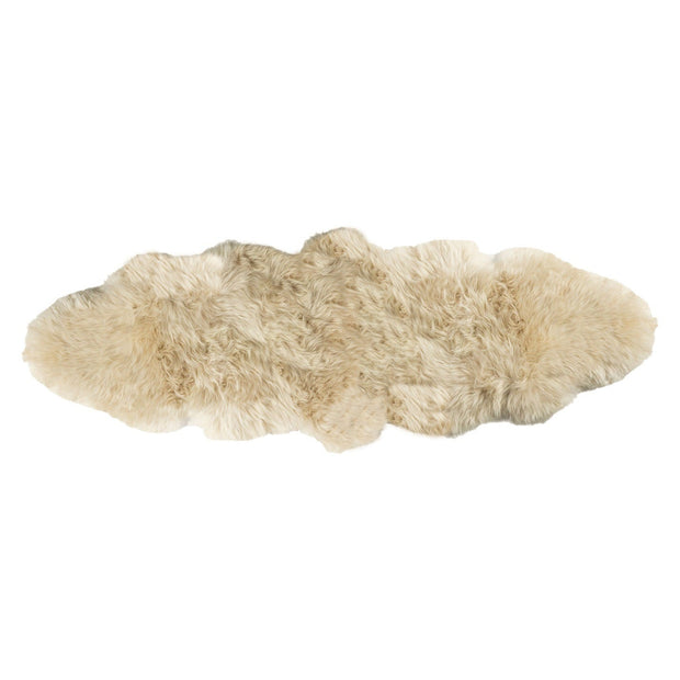 A beige-colored double longwool sheepskin rug laid out on a plain background.