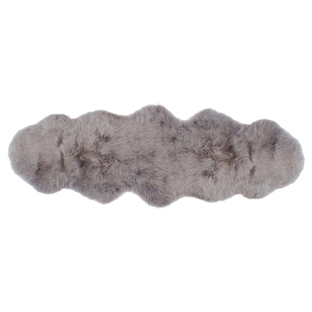 A premium sheepskin rug with a beige and white color, displayed on a white background.