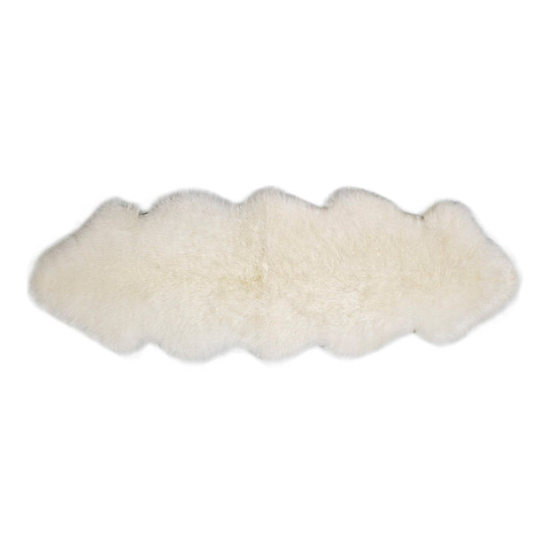 A long white wool rug with a plush texture, displayed on a clear background.