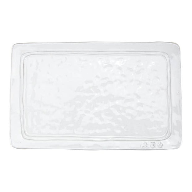 A white rectangular ceramic platter with a textured surface.