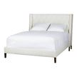 A white, upholstered king-sized bed frame with a high headboard and footboard, pictured with white bedding.