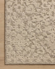 Close-up of a corner of a Loloi Prudence rug showing a hand-tufted floral pattern in stone and ivory colors.