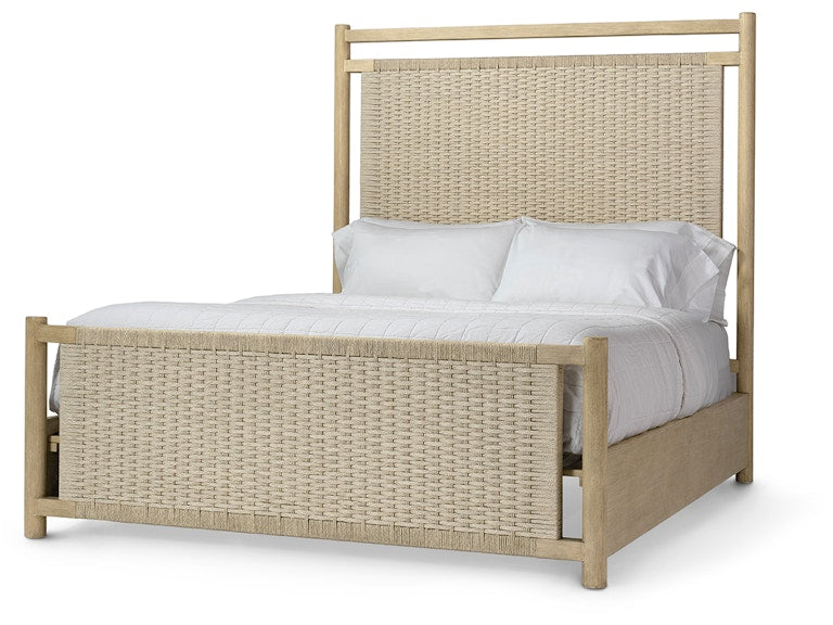 A light natural wood bed frame with woven rattan panels on the headboard and footboard, styled with white bedding and pillows against a plain white background.