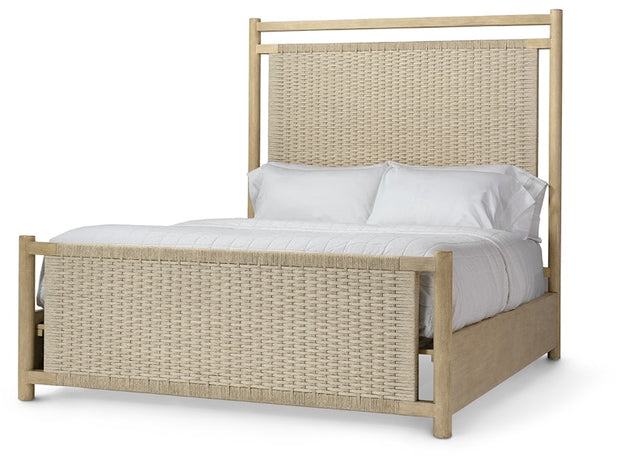 A light natural wood bed frame with woven rattan panels on the headboard and footboard, styled with white bedding and pillows against a plain white background.