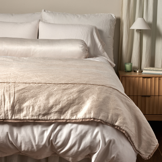 Bella Notte Paloma silk charmeuse throw blanket in pearl color, showcasing its soft, luxurious fabric and elegant drape.