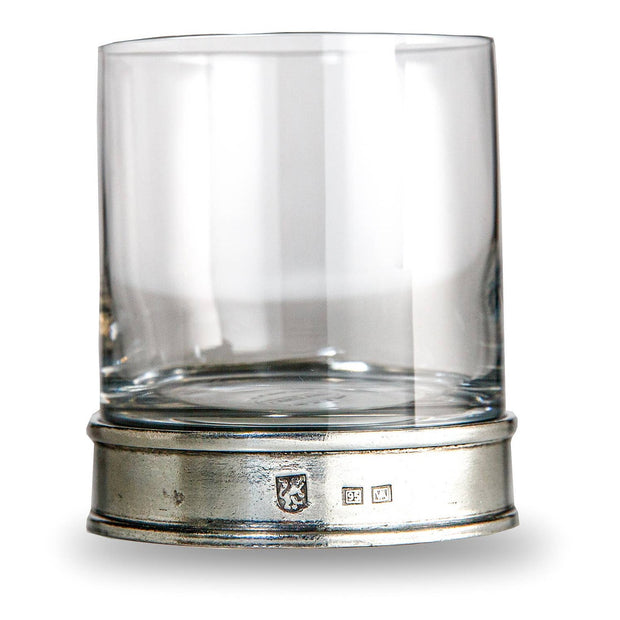 A clear round glass lowball glass with a pewter base, featuring the Arte Italica logo, hand made in Italy.