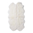 A natural-shaped white sheepskin rug