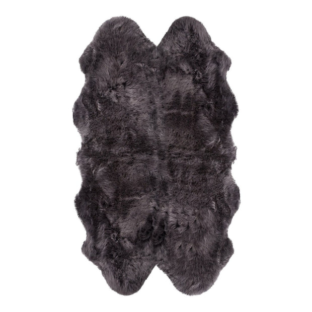 A natural-shaped black sheepskin rug