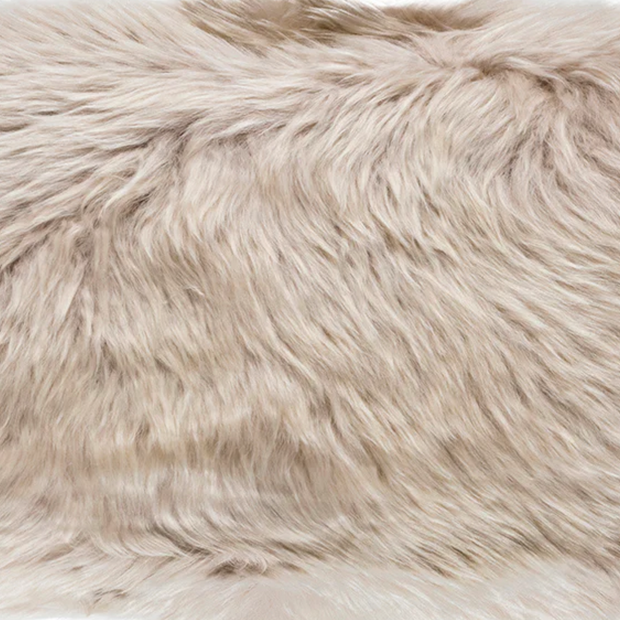 A natural-shaped white sheepskin rug