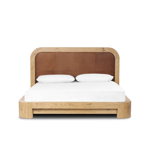 Wooden bed with a brown headboard and white bedding on a white background