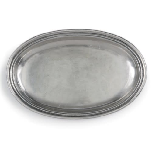 A silver-colored Arte Italica Roma Peltro small oval dish with rustic edging.