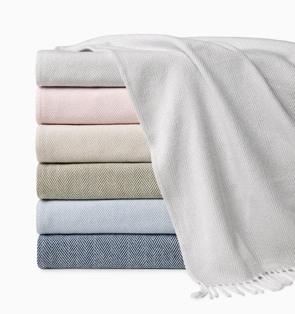 Stack of folded towels in various colors on a white background
