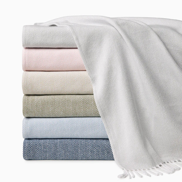 Stack of folded towels in various colors on a white background