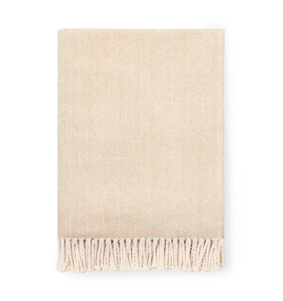 Beige woven blanket with fringes on a white background