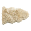 A beige longwool rug with a plush texture, shaped like a rectangle.