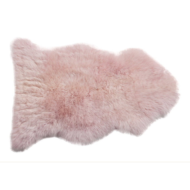 A powder rose colored longwool rug with a plush texture, displayed on a white background.