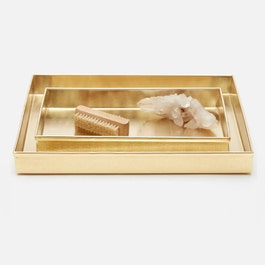 Gold-framed display case with a brush and a small figurine on a white background