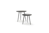 Two round walnut nesting tables with hand-hammered steel legs, one larger than the other, on a white background.