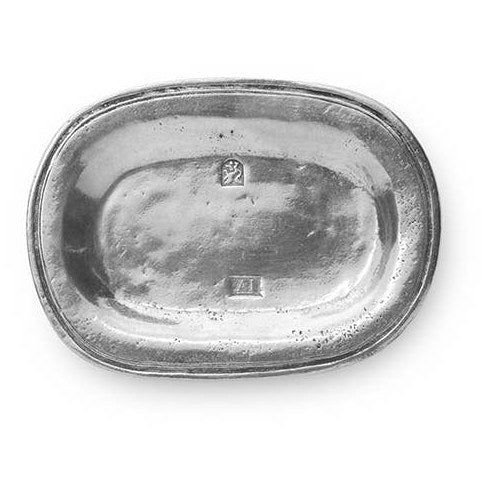 A silver-colored oval-shaped vintage-style small tray, likely made of pewter, with a textured surface and a small emblem in the center.