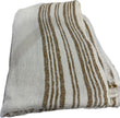 Sienna Ochre Bed End Throw by Adelene, soft fabric with textured pattern, placed at the end of a bed in a cozy bedroom setting.