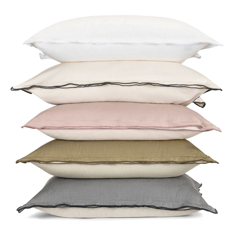Set of two Adelene Kinfolk king-sized shams in bleached white, featuring a soft, smooth fabric and decorative pillow edges.