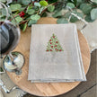 White, green, and red Holly Tree tri-fold napkin from Arte Italica and Crown Linen Designs, featuring festive holiday table linen design.