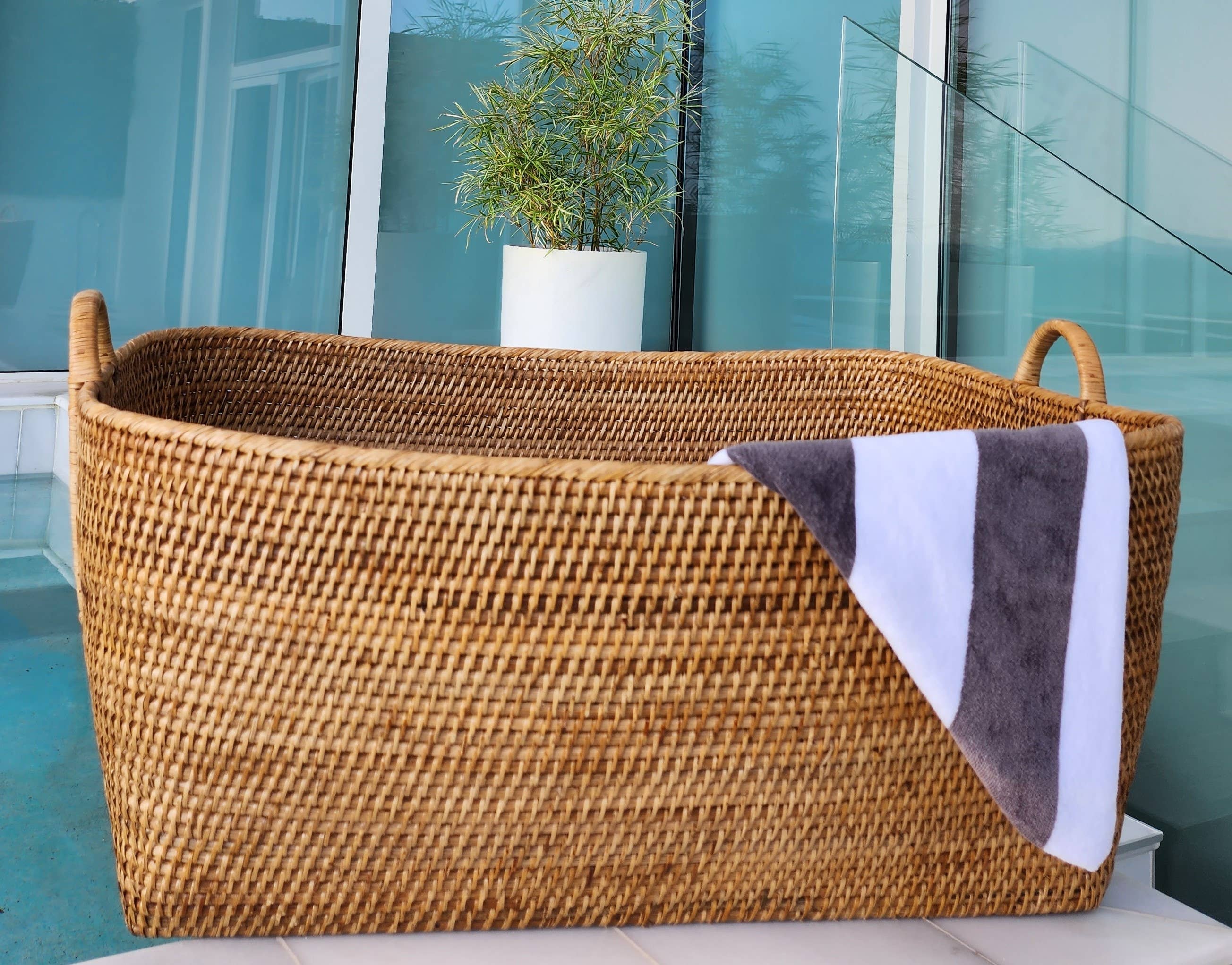 Honey brown rattan everything basket with hoop handles, crafted by Artifacts Trading Company for versatile storage.