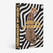 Assouline African Adventures decor book featuring vibrant images of African landscapes and cultural scenes.