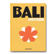Book cover of 'Bali Mystique' by Assouline with a yellow background, black text, and a red flower graphic.
