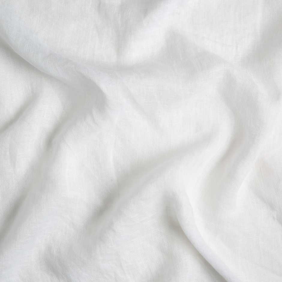Linen Whisper crib skirt by Bella Notte in Winter White with a soft swirl pattern, made of elegant linen fabric.
