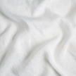 Linen Whisper crib skirt by Bella Notte in Winter White with a soft swirl pattern, made of elegant linen fabric.