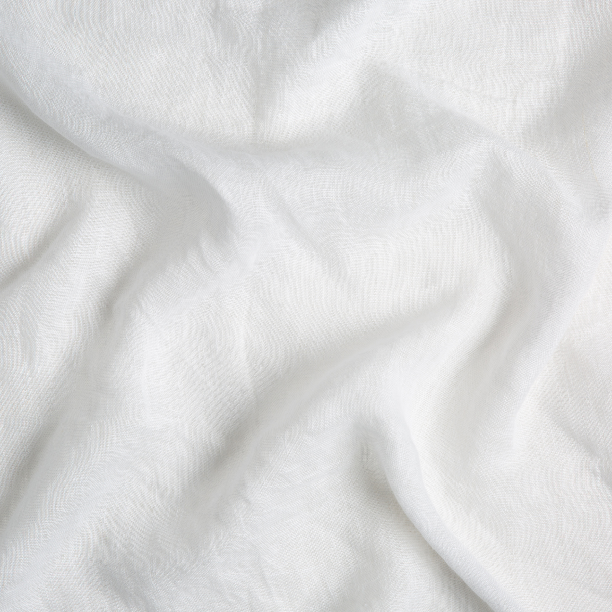 Linen Whisper crib skirt by Bella Notte in Winter White with a soft swirl pattern, made of elegant linen fabric.