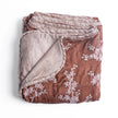 Bella Notte Lynette Throw Blanket in Tahoe Blue, soft and cozy with a luxurious fabric, perfect for adding warmth and style to a sofa.
