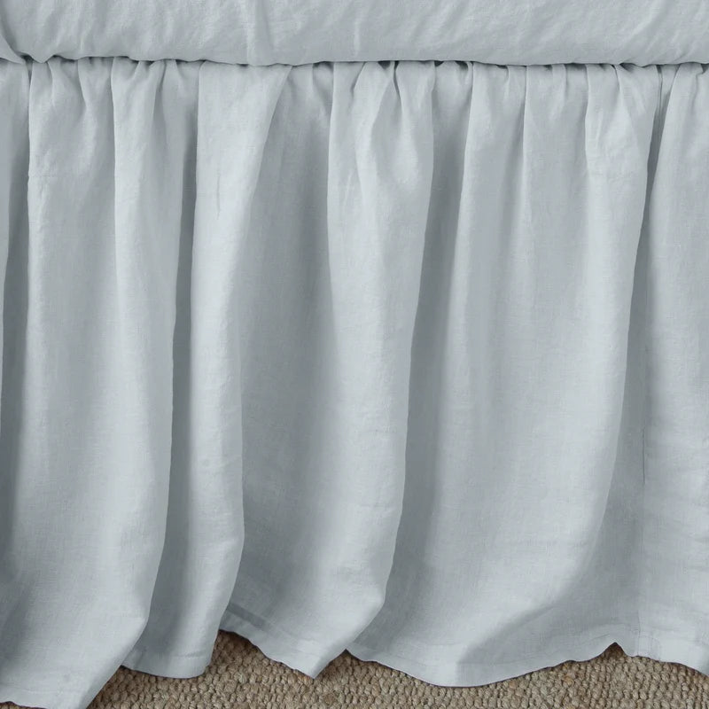 Bella Notte linen bed panel bed skirt in autumn color, showing a neatly draped twin-size linen bed skirt on a bed.